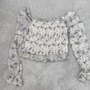 Floral shirt off the shoulder or on the shoulder depending how you want to wear